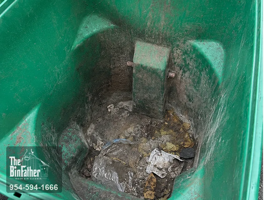 The base of a badly neglected cart, trash bin cleaning in South Florida — before cleaning